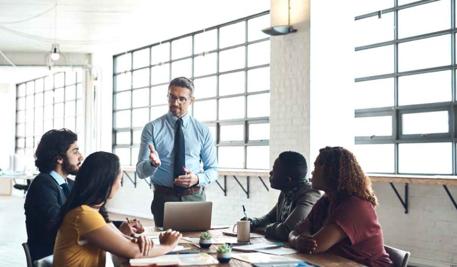 Laptop, manager or businessman in presentation for solution, problem solving or teaching in meeting. Leadership, workshop or mentor talking in team training, coaching class or learning opportunity