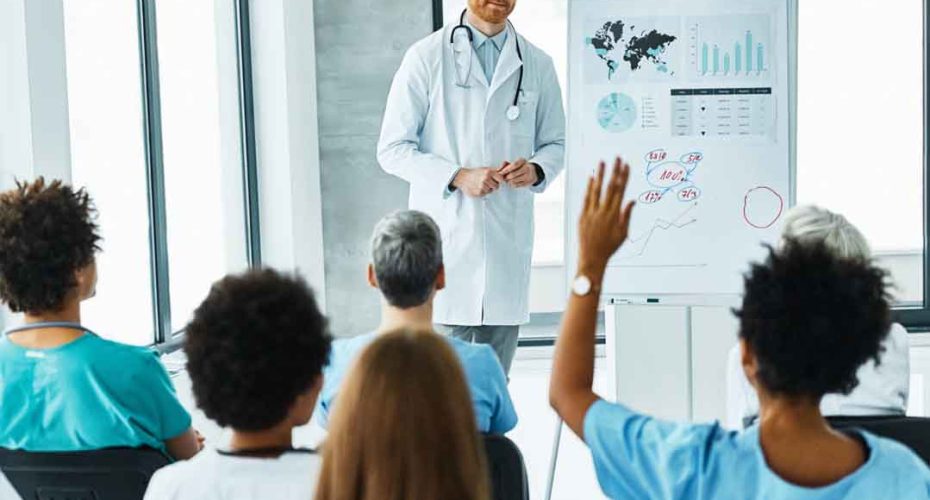 Portrait of a young doctor teaching on a seminar in a board room or during an educational class at convention center